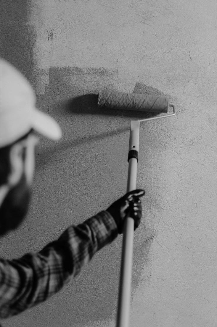 Preparing and rolling a fresh coat on an interior wall