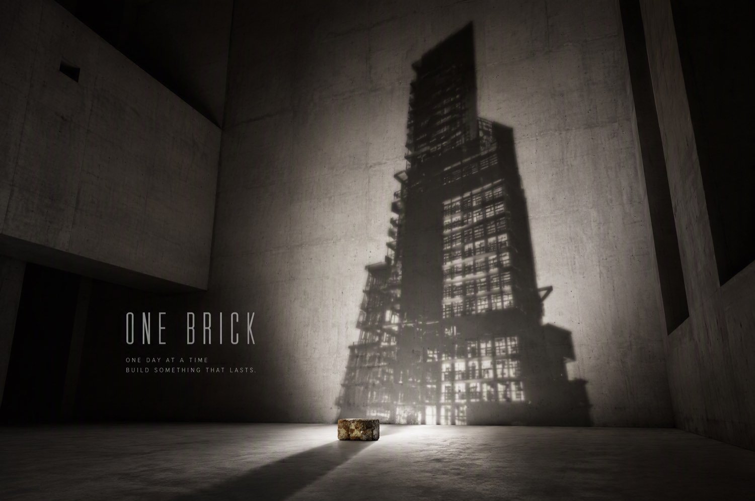 A single brick casts the shadow of a high-rise tower — build something that lasts, one day at a time.